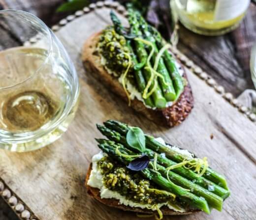 Bruschetta with warm goat cheese, roasted asparagus, and pistachio pesto