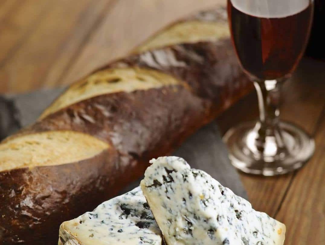 bread, blue cheese, and port wine on a table