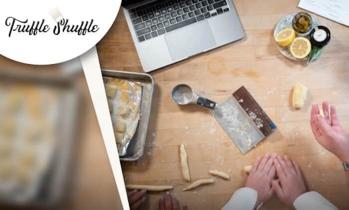 truffle shuffle company logo over image of people cooking on table with laptop near