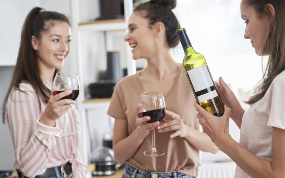 woman standing around with wine glasses in hand