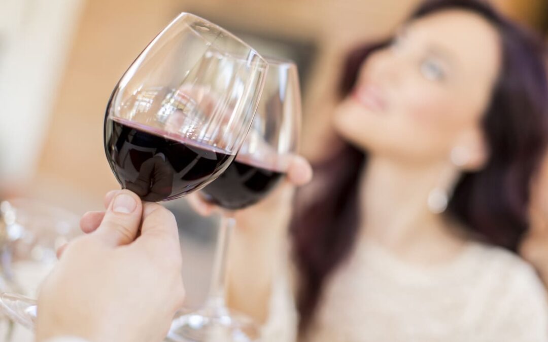 people clinking wine glasses together