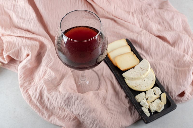 a-glass-of-wine-with-cheese-plate
