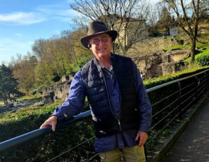 Scott with old buildings behind him