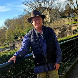 Scott with old buildings behind him
